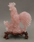 A Chinese carved rose quartz cockerel, on stand. 22.5 cm high overall.