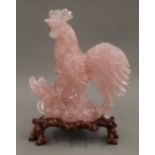 A Chinese carved rose quartz cockerel, on stand. 22.5 cm high overall.