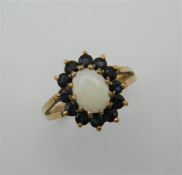 A 9 ct gold opal and sapphire ring. Ring size O.