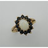 A 9 ct gold opal and sapphire ring. Ring size O.