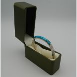 A silver and turquoise bracelet. 6.5 cm wide. 36 grammes total weight.