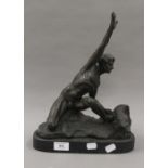 A bronze model of a man on a rock. 36 cm high.