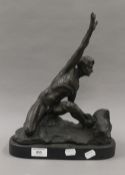 A bronze model of a man on a rock. 36 cm high.