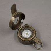 A brass compass. 6 cm wide.