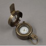 A brass compass. 6 cm wide.