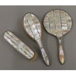 A mother-of-pearl and silver dressing table set