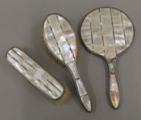 A mother-of-pearl and silver dressing table set