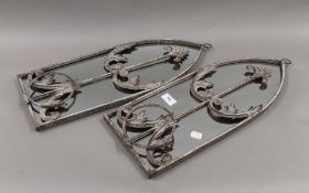 A pair of arched garden mirrors with pots. 55.5 cm high.