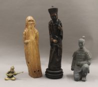 A Chinese carved wooden statue of a sage, a resin figure of a Chinese official,