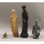 A Chinese carved wooden statue of a sage, a resin figure of a Chinese official,