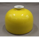 A Chinese yellow porcelain brush pot. 8 cm high.