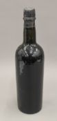 A single bottle of 1920 vintage port. 29 cm high.