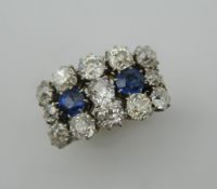 An 18 ct gold and platinum, diamond and sapphire three row cluster ring. 1.3 cm high.