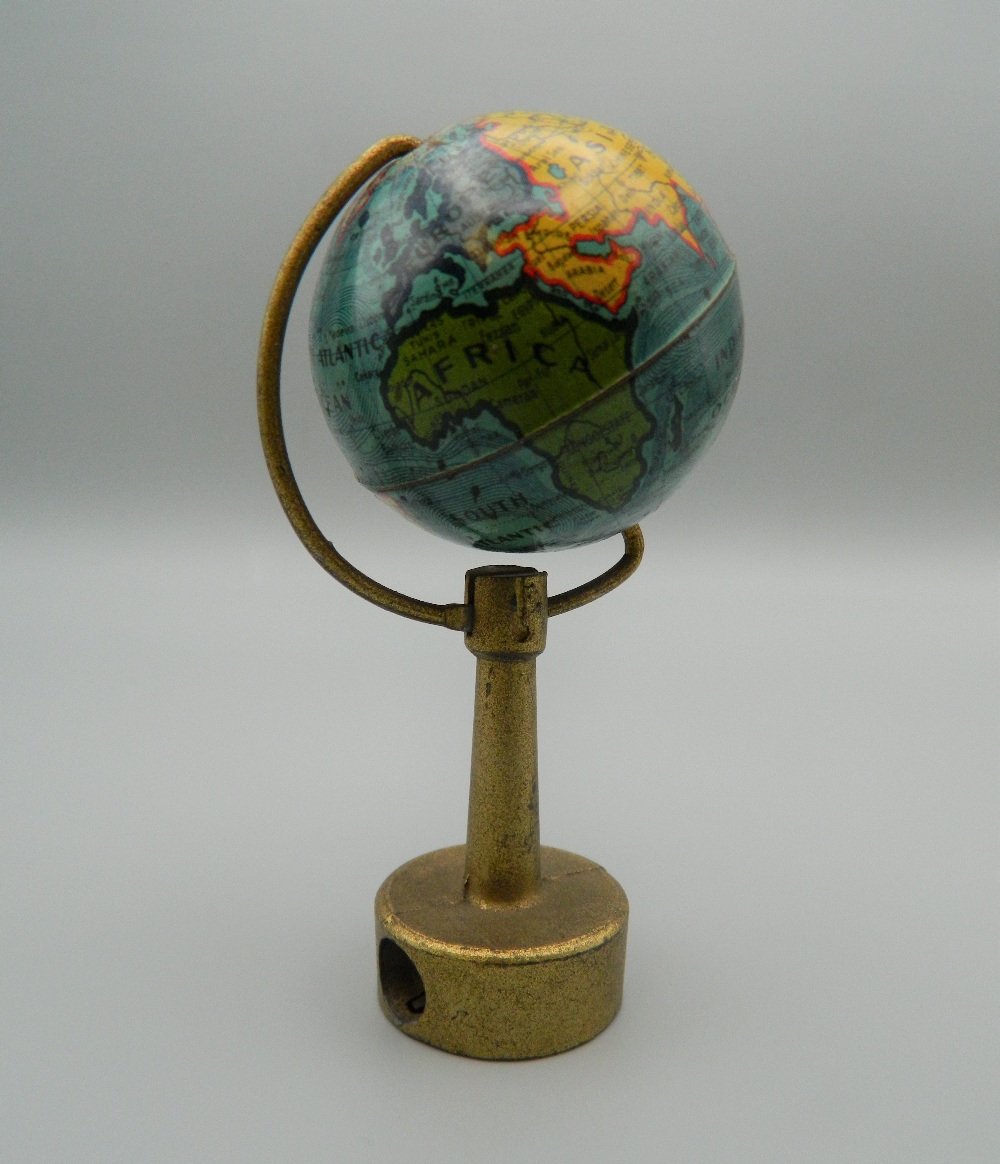 A vintage novelty pencil sharpener formed as a globe. 9 cm high.