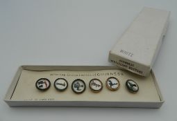 A boxed set of vintage Guinness waistcoat buttons