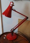 A red anglepoise lamp