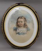 A Victorian portrait of a girl, pastel, framed and glazed. 65 cm high.