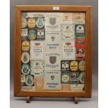 A Cambridge College beer mat fire screen. 51.5 cm wide.