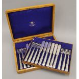 A canteen of silver plated fish cutlery. 35 cm wide.