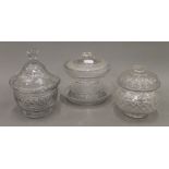 Three 19th century cut glass lidded bon bon dishes. The largest 16 cm high.