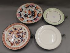 Four Victorian warming plates. The largest 27 cm diameter.