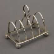 A miniature silver toast rack.