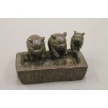 A small bronze model of three pigs at a trough. 4.5 cm wide.