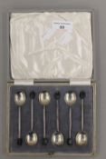 A cased set of silver coffee bean spoons. 51.4 grammes total weight.