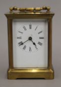 A brass cased carriage clock. 14 cm high.