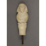 A 19th century ivory walking stick handle carved as an Egyptian figure. 8.5 cm high.