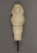 A 19th century ivory walking stick handle carved as an Egyptian figure. 8.5 cm high.