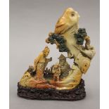 A fine quality Chinese soapstone carving of a scholarly figure and a child in a mountainous