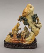 A fine quality Chinese soapstone carving of a scholarly figure and a child in a mountainous