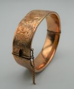 A 9 ct gold bangle form bracelet. 7 cm wide. 24.9 grammes.