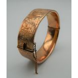 A 9 ct gold bangle form bracelet. 7 cm wide. 24.9 grammes.