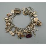 A silver charm bracelet. 88.1 grammes total weight.
