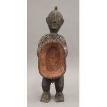 An African carved wooden tribal figure of a male. 22.5 cm high.