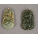 Two jade pendants, each with gold suspension loops. Each 3.5 cm high.