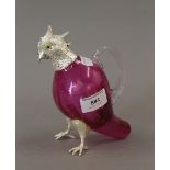 A silver plate mounted cranberry glass claret jug formed as a bird. 16 cm high.
