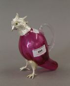 A silver plate mounted cranberry glass claret jug formed as a bird. 16 cm high.
