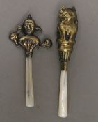 Two brass novelty rattles. The largest 11 cm high.