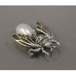 A silver dress brooch formed as a fly. 3 cm long.