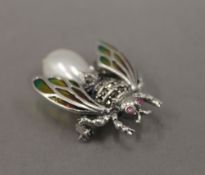 A silver dress brooch formed as a fly. 3 cm long.