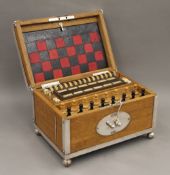 A late 19th/early 20th century silver plate mounted fitted games compendium, complete with key. 32.