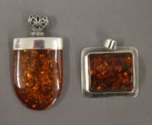 Two silver dress pendants. The largest 3.5 cm high.