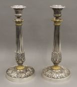 A pair of 19th century gilt heightened silver plated candlesticks. 27 cm high.