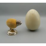 A silver chick form pin cushion, housed in a lined egg shaped box. The pin cushion 4.5 cm high.