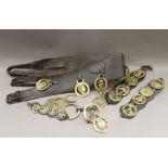 A quantity of horse brasses and straps.