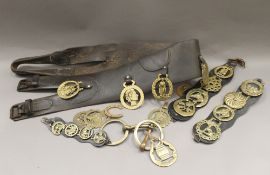 A quantity of horse brasses and straps.