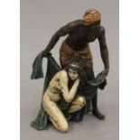 A cold painted bronze model of an Arab and nude. 14 cm high.